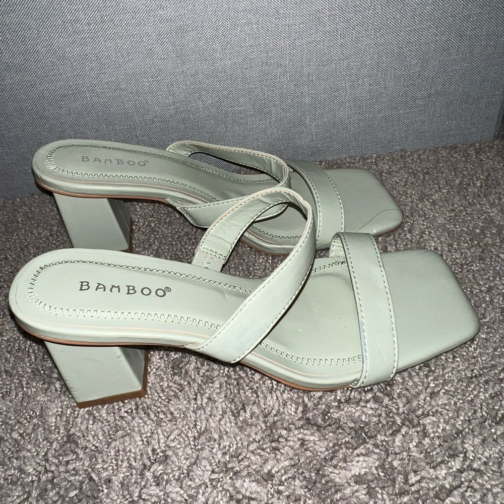 Light green heeled sandals.